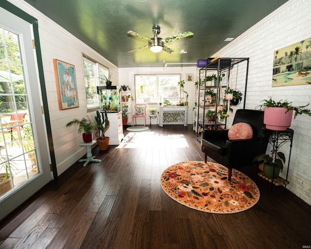 3945 W Walnut Leaf Dr, Bloomington, IN 47403 - sitting room featuring a ceiling fan, hardwood / wood-style floors, and brick wall