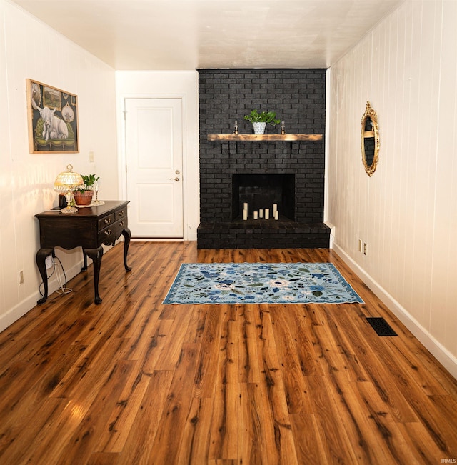 3945 W Walnut Leaf Dr, Bloomington, IN 47403 - living room featuring wood finished floors and a brick fireplace