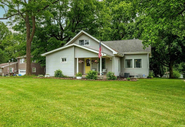 2220 N Huntington Rd, Marion, IN 46952 - view of front of property featuring covered porch, a front lawn, roof with shingles, and view of scattered trees