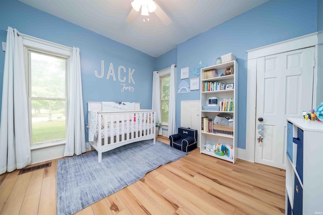 2220 N Huntington Rd, Marion, IN 46952 - bedroom with wood finished floors, a nursery area, and a ceiling fan