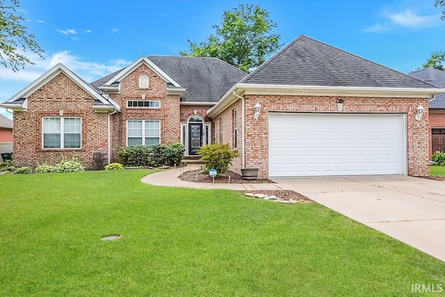 2433 Wheaton Dr, Evansville, IN 47725 - view of front of house with roof with shingles, brick siding, a front lawn, driveway, and an attached garage