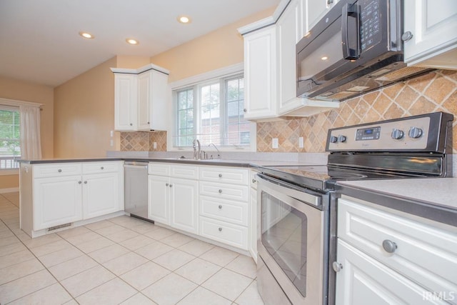 2433 Wheaton Dr, Evansville, IN 47725 - kitchen with stainless steel appliances, tasteful backsplash, a peninsula, white cabinets, and recessed lighting