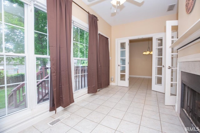 2433 Wheaton Dr, Evansville, IN 47725 - doorway to outside featuring french doors, light tile patterned floors, a ceiling fan, and a fireplace