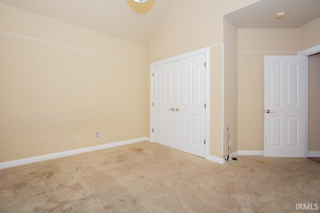 2433 Wheaton Dr, Evansville, IN 47725 - unfurnished bedroom featuring carpet, vaulted ceiling, and a closet
