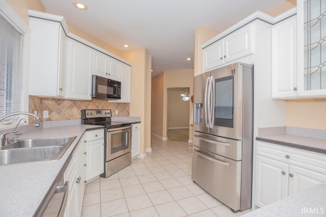 2433 Wheaton Dr, Evansville, IN 47725 - kitchen featuring appliances with stainless steel finishes, light tile patterned floors, white cabinets, and recessed lighting