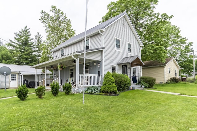 200 Pyle St, Geneva, IN 46740 - view of front of home featuring ceiling fan, a porch, a front lawn, an outdoor structure, and board and batten siding