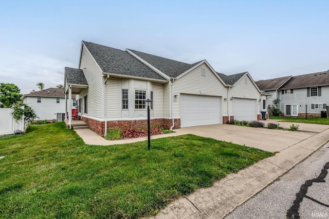 1423 W Westwind Ct, Bloomington, IN 47403 - view of front of house featuring a garage, concrete driveway, a front yard, a shingled roof, and brick siding