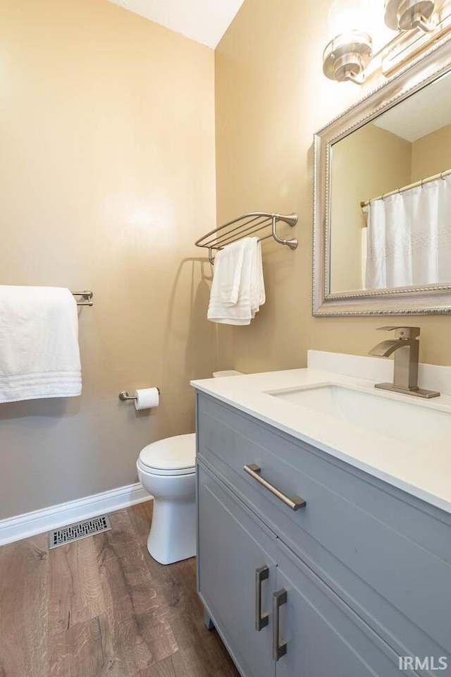 1423 W Westwind Ct, Bloomington, IN 47403 - full bathroom with vanity and wood finished floors
