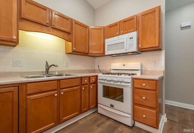 1423 W Westwind Ct, Bloomington, IN 47403 - kitchen featuring white appliances, dark wood finished floors, light countertops, and brown cabinetry