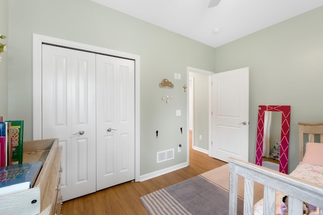 215 Mockingbird Ln, Warsaw, IN 46580 - bedroom with wood finished floors, a closet, and a ceiling fan