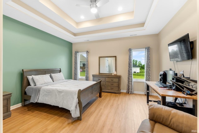 215 Mockingbird Ln, Warsaw, IN 46580 - bedroom featuring light wood finished floors, a tray ceiling, and a ceiling fan