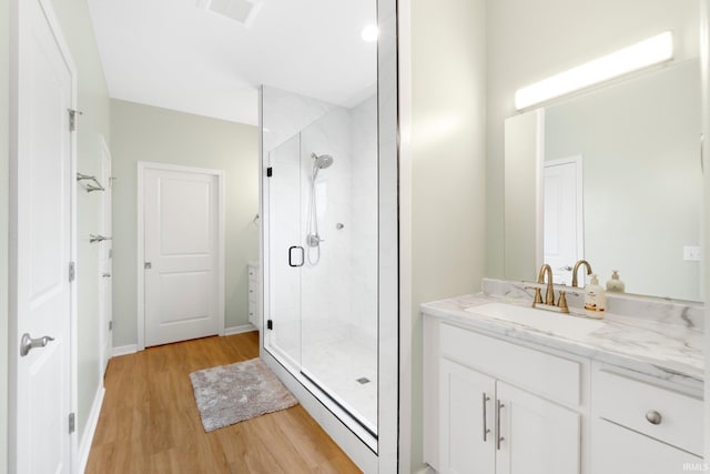 215 Mockingbird Ln, Warsaw, IN 46580 - bathroom with vanity, wood finished floors, and a shower stall