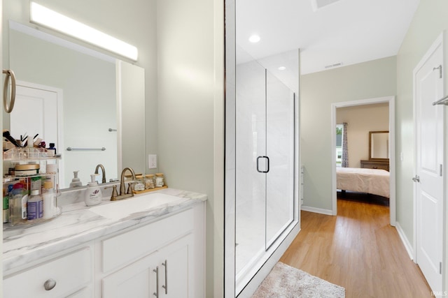 215 Mockingbird Ln, Warsaw, IN 46580 - full bath with wood finished floors, a shower stall, vanity, and connected bathroom