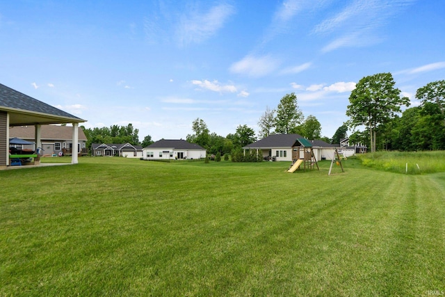 215 Mockingbird Ln, Warsaw, IN 46580 - view of grassy yard featuring a playground