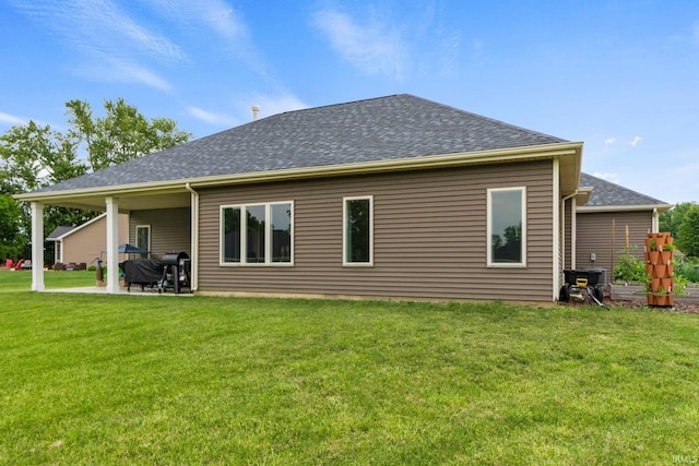 215 Mockingbird Ln, Warsaw, IN 46580 - back of house featuring a yard, a shingled roof, and a patio area
