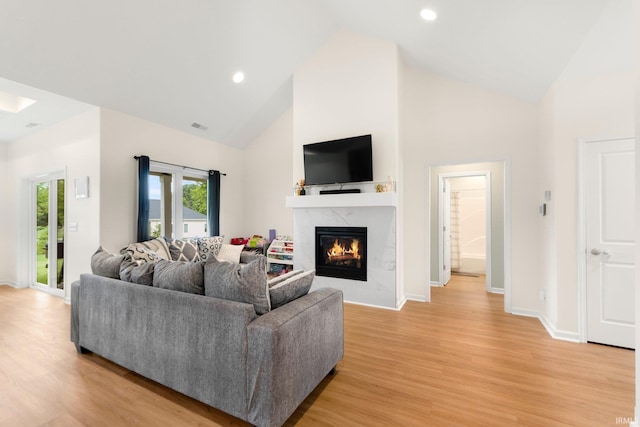 215 Mockingbird Ln, Warsaw, IN 46580 - living room featuring high vaulted ceiling, light wood-type flooring, a high end fireplace, and recessed lighting