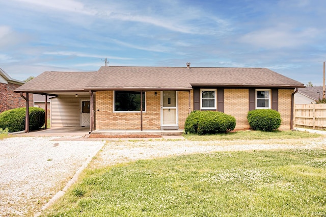 6412 E Oak St, Evansville, IN 47715 - single story home featuring driveway, an attached carport, brick siding, and a shingled roof
