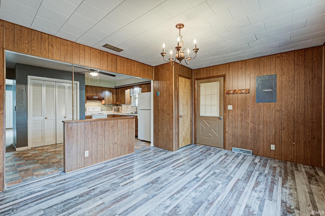 6412 E Oak St, Evansville, IN 47715 - kitchen with freestanding refrigerator, stove, a chandelier, under cabinet range hood, and light countertops