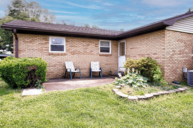 6412 E Oak St, Evansville, IN 47715 - back of house featuring a yard, a patio area, brick siding, and roof with shingles