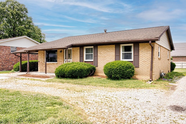 6412 E Oak St, Evansville, IN 47715 - ranch-style home with brick siding, a shingled roof, and driveway