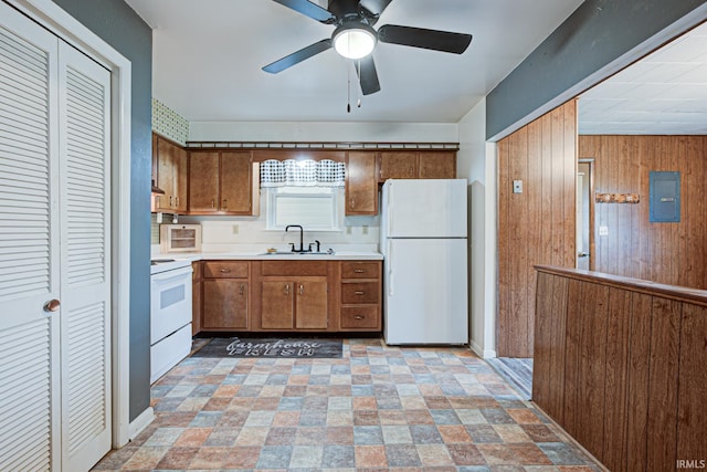 6412 E Oak St, Evansville, IN 47715 - kitchen featuring white appliances, brown cabinets, wooden walls, light countertops, and ceiling fan