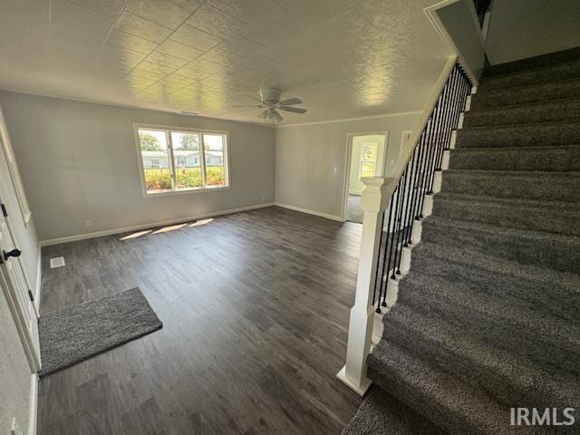 11748 W 450 N, Cromwell, IN 46732 - unfurnished living room featuring stairs, ceiling fan, and dark wood-style flooring