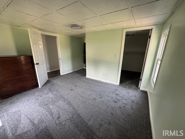 11748 W 450 N, Cromwell, IN 46732 - unfurnished bedroom featuring carpet floors, a drop ceiling, a spacious closet, and a closet