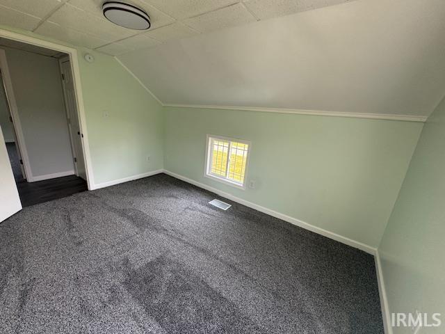 11748 W 450 N, Cromwell, IN 46732 - additional living space featuring dark colored carpet and vaulted ceiling