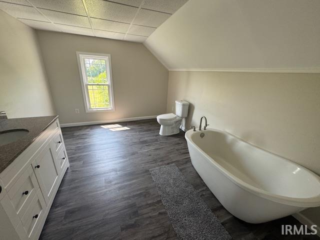 11748 W 450 N, Cromwell, IN 46732 - full bathroom with vanity, a freestanding bath, wood finished floors, and vaulted ceiling