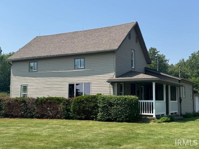 11748 W 450 N, Cromwell, IN 46732 - view of side of property featuring a porch, a lawn, and roof with shingles