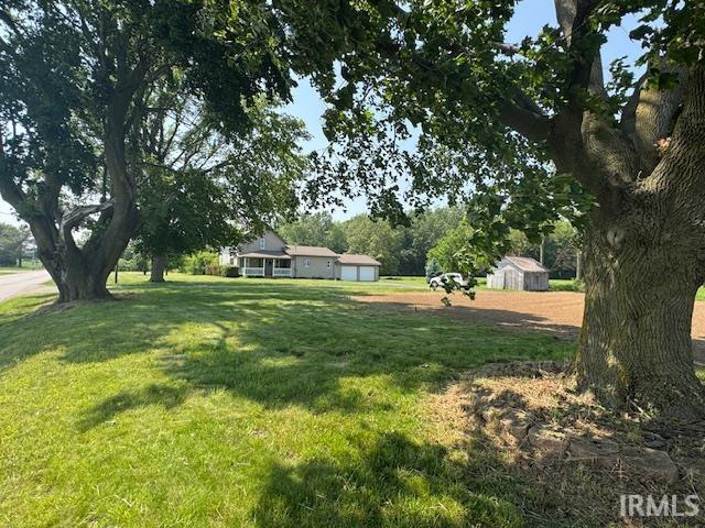 11748 W 450 N, Cromwell, IN 46732 - view of grassy yard with a garage