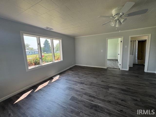 11748 W 450 N, Cromwell, IN 46732 - empty room with dark wood-type flooring, a ceiling fan, and crown molding