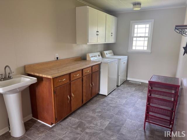 11748 W 450 N, Cromwell, IN 46732 - washroom with cabinet space, washing machine and dryer, and ornamental molding