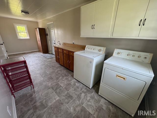 11748 W 450 N, Cromwell, IN 46732 - washroom featuring cabinet space and separate washer and dryer