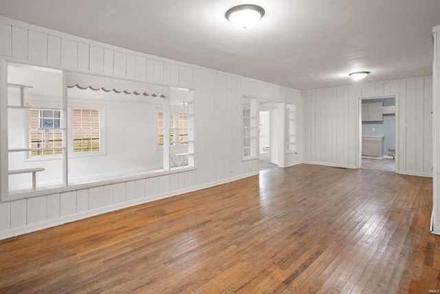 2305 N Armstrong St, Kokomo, IN 46901 - spare room featuring hardwood / wood-style flooring and wooden walls