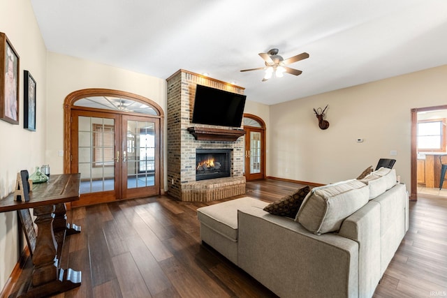 5595 N State Road 109, Columbia City, IN 46825 - living room with french doors, wood finished floors, a ceiling fan, and a brick fireplace
