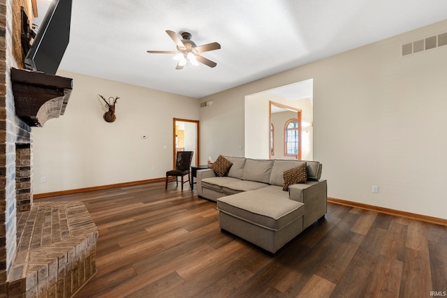 5595 N State Road 109, Columbia City, IN 46825 - living room featuring a ceiling fan, a fireplace, and dark wood-style flooring
