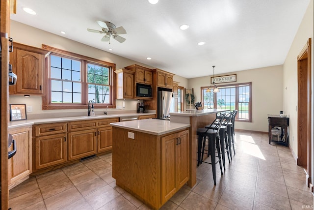 5595 N State Road 109, Columbia City, IN 46825 - kitchen with stainless steel appliances, a kitchen island, plenty of natural light, a breakfast bar area, and recessed lighting