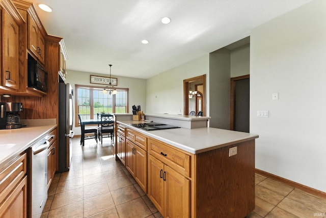 5595 N State Road 109, Columbia City, IN 46825 - kitchen featuring black appliances, a center island, light countertops, pendant lighting, and recessed lighting