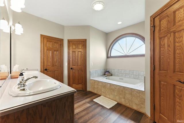 5595 N State Road 109, Columbia City, IN 46825 - bathroom featuring double vanity, a garden tub, and wood finished floors