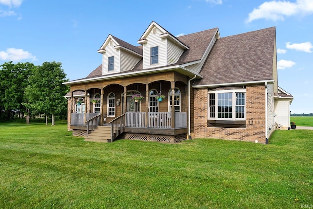 5595 N State Road 109, Columbia City, IN 46825 - view of front of home with a porch, a front lawn, brick siding, and a shingled roof