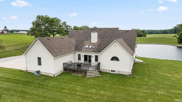 5595 N State Road 109, Columbia City, IN 46825 - back of house featuring a deck with water view, a yard, a chimney, and a shingled roof