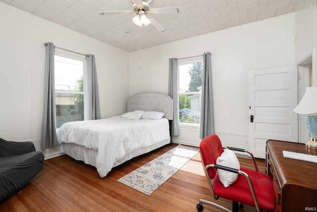 102 E Peterson St, Otterbein, IN 47970 - bedroom featuring wood finished floors, multiple windows, and ceiling fan