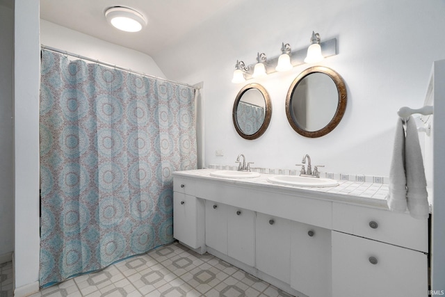 102 E Peterson St, Otterbein, IN 47970 - full bathroom featuring double vanity, tile patterned floors, lofted ceiling, and curtained shower
