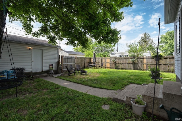 102 E Peterson St, Otterbein, IN 47970 - fenced backyard with a fire pit