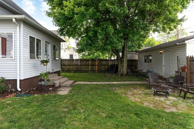 102 E Peterson St, Otterbein, IN 47970 - fenced backyard with entry steps and a fire pit
