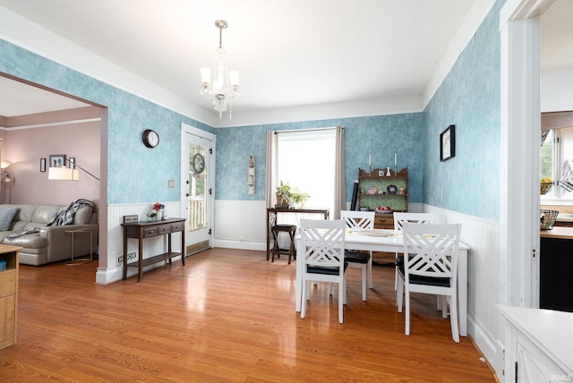 102 E Peterson St, Otterbein, IN 47970 - dining space featuring wallpapered walls, a chandelier, wainscoting, and light wood-style flooring