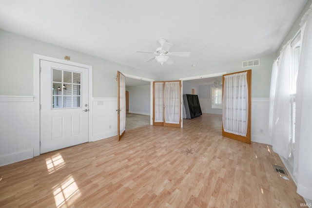 7404 N State Road 13, North Webster, IN 46555 - spare room featuring a wainscoted wall, light wood-type flooring, and ceiling fan