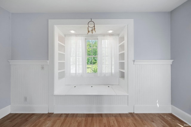 7404 N State Road 13, North Webster, IN 46555 - interior space featuring wood finished floors, wainscoting, and a chandelier