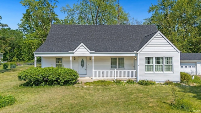 7404 N State Road 13, North Webster, IN 46555 - view of front of property with a porch, a front yard, and a shingled roof